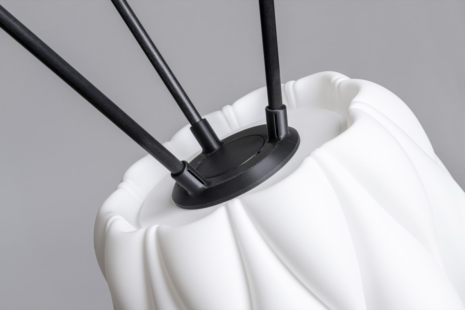 3D printed pleated lamp with black wooden rods