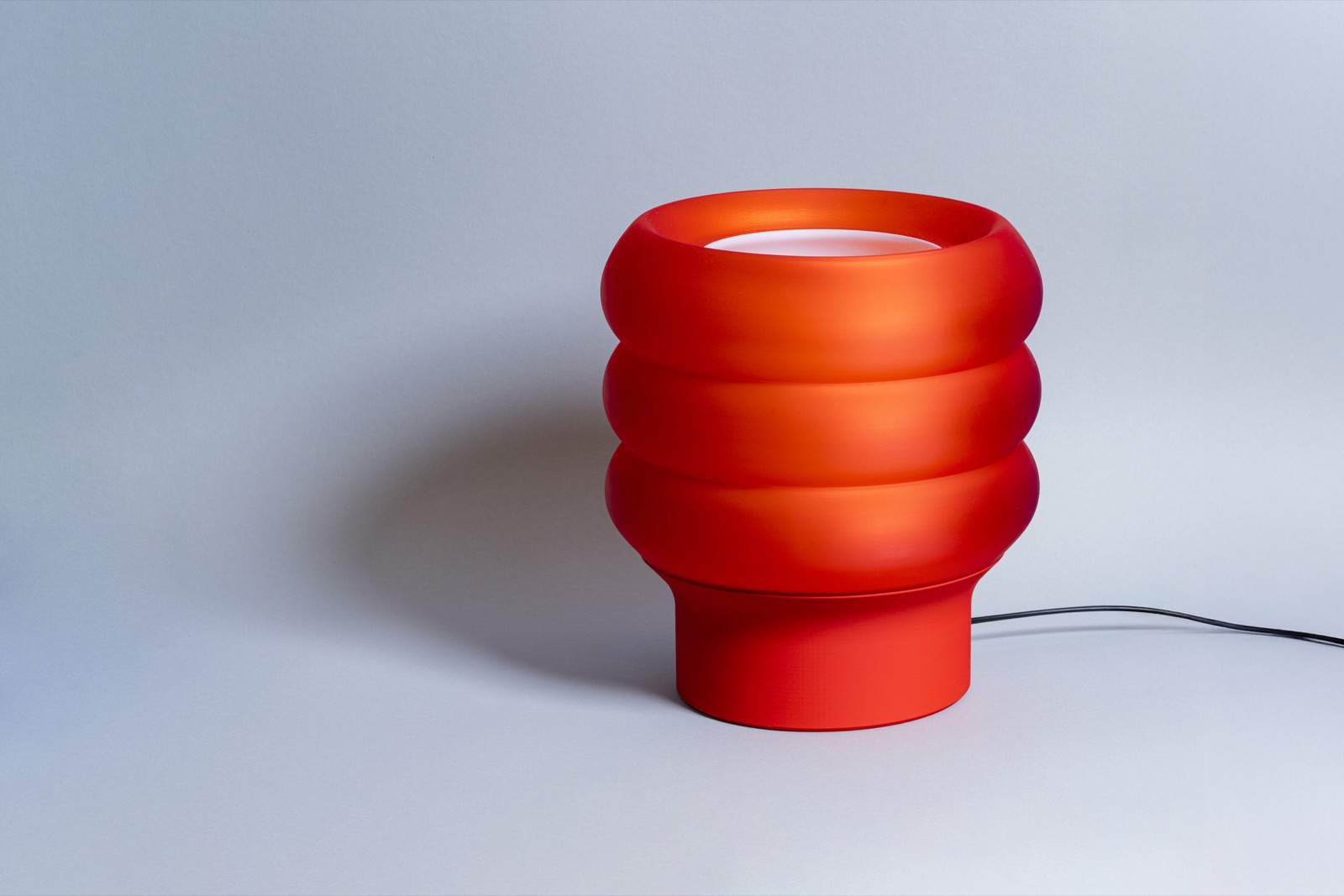 Modo lamp glowing red on a sideboard
