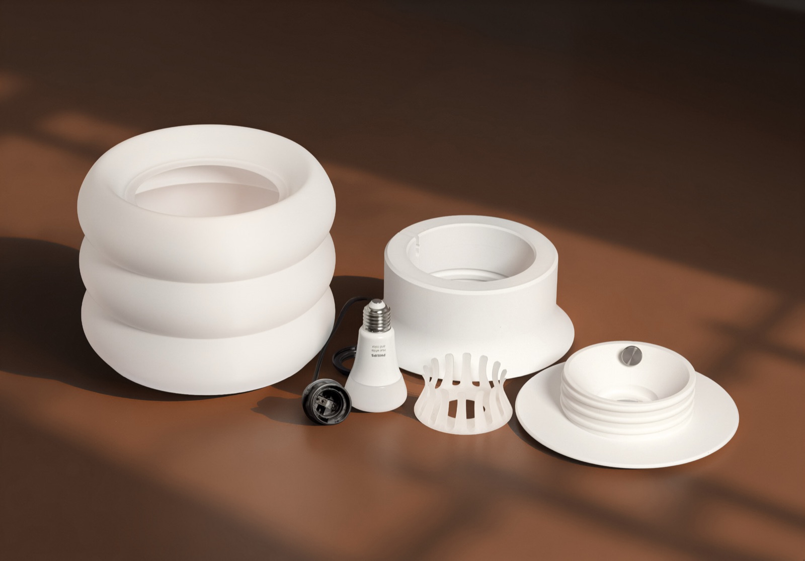 Modo lamp disassembled into its red and white parts