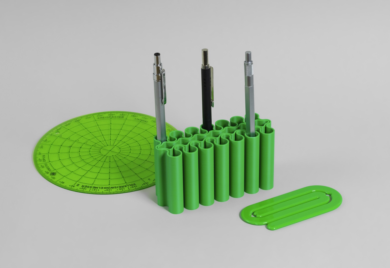 Green 3D printed pen holder with drafting templates